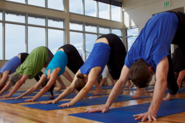 Students doing Downward Dog in a group class at Yoga Shala in Boulder Colorado